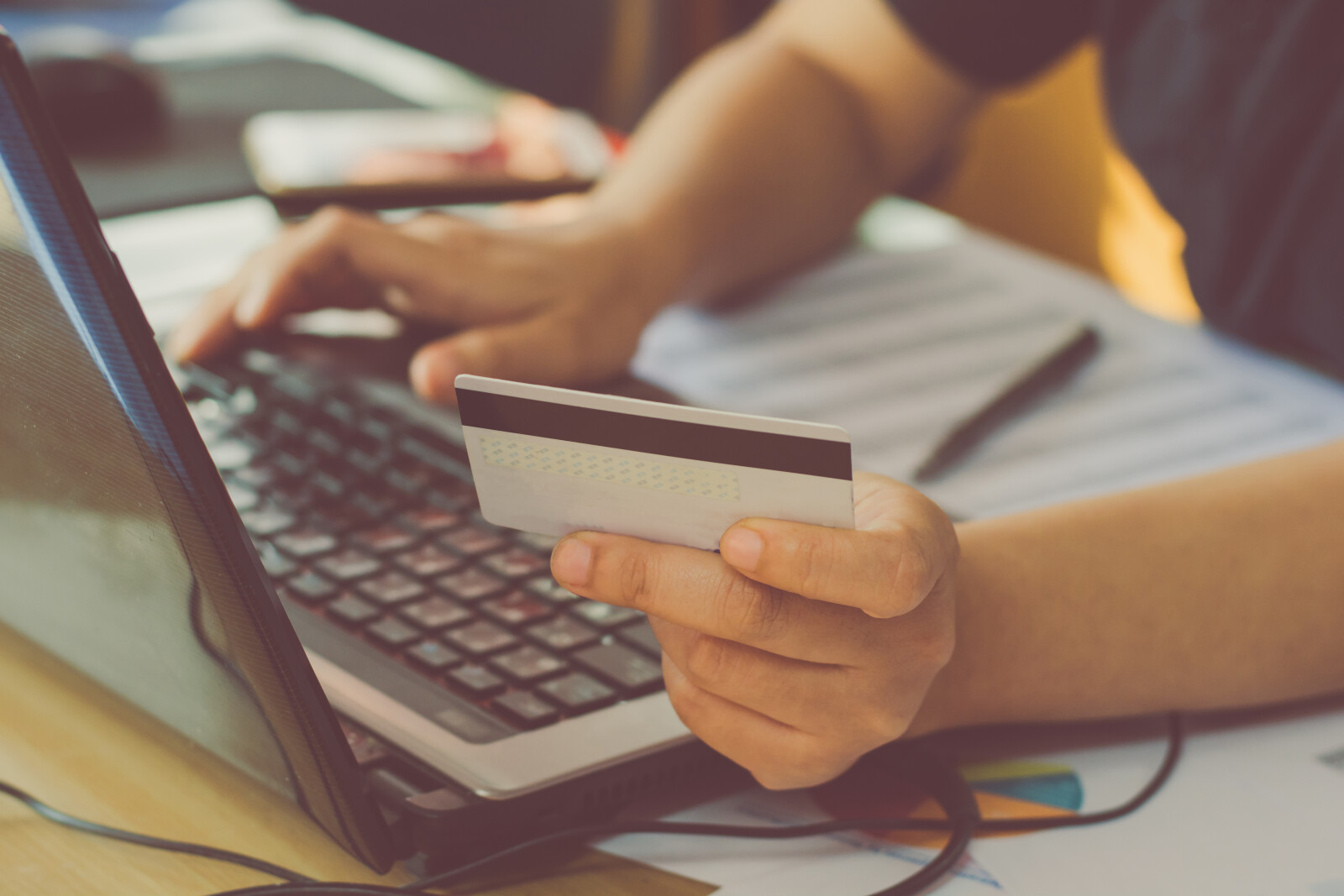 woman hand holding credit card and using laptop making online payment
